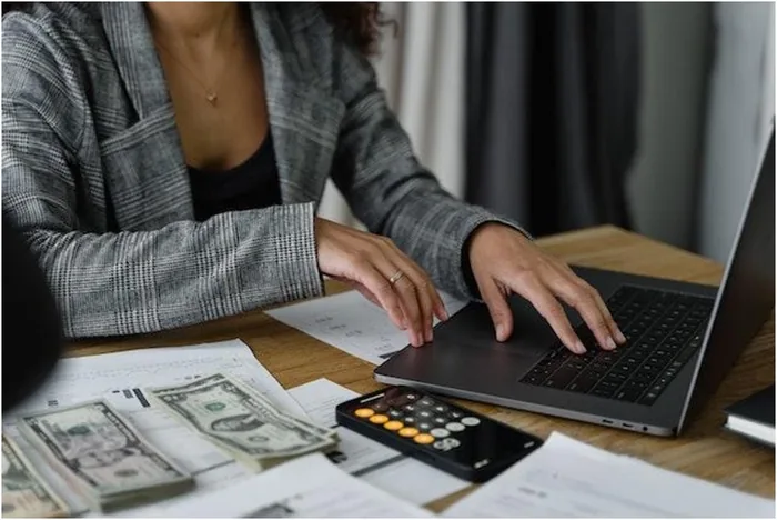 Money calculator and a laptop