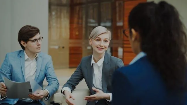 Two people talking to a landlord about a rental application