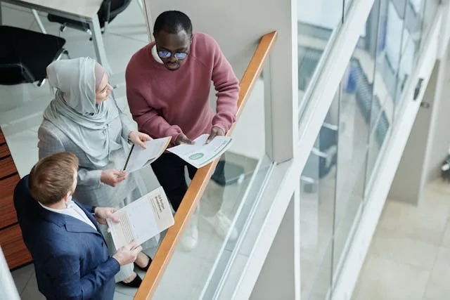 Three people discussing document