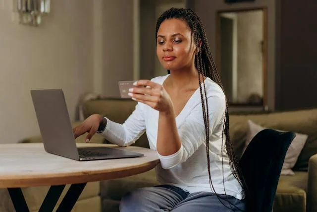 Tenant looking at their credit card at they pay rent online